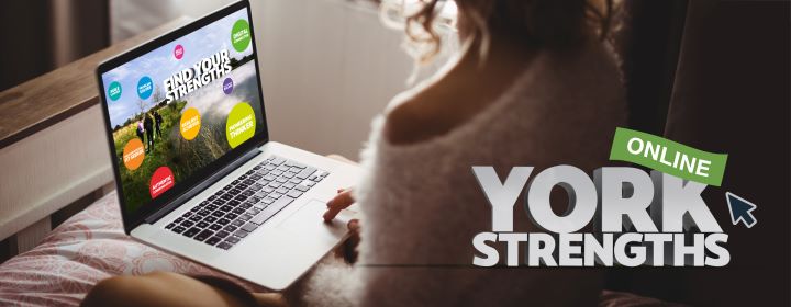girl sat at computer with York Strengths web page open